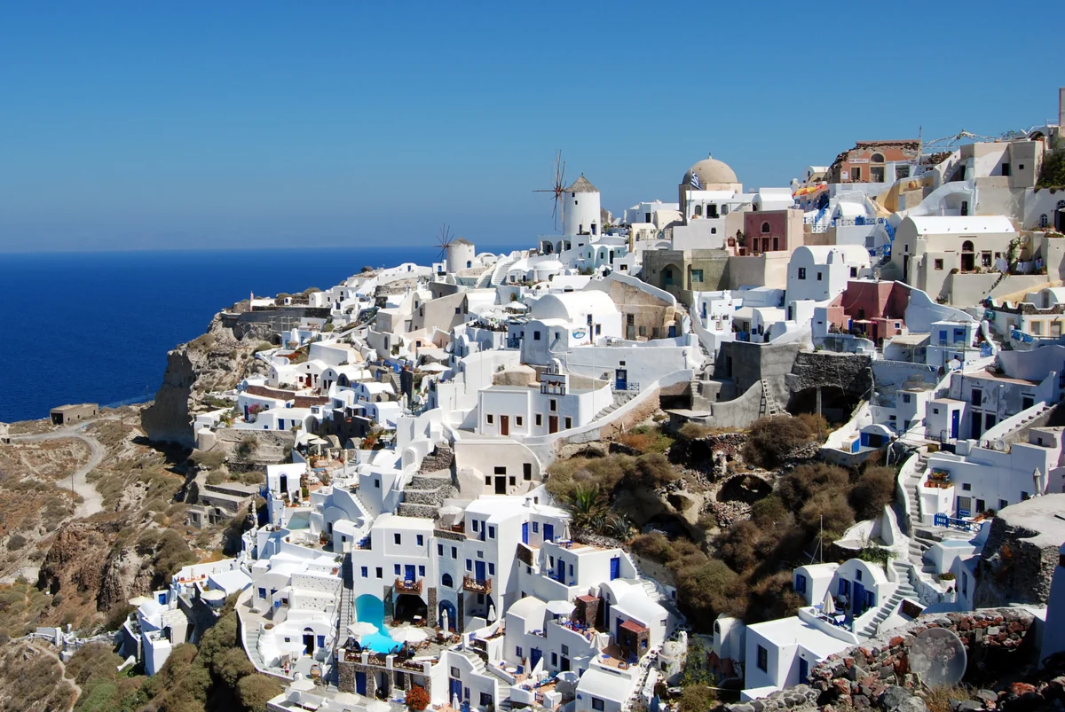 White houses and blue domes above the Santorini caldera.